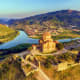 Jvari Monastery overlooking the Mtkvari River and town of Mtskheta in Georgia, surrounded by green mountains and valley lands